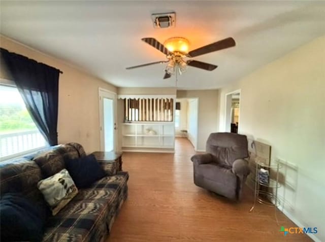 living room with hardwood / wood-style floors and ceiling fan