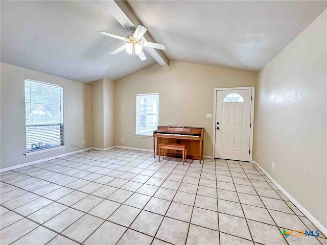 tiled foyer featuring lofted ceiling with beams, a healthy amount of sunlight, and ceiling fan