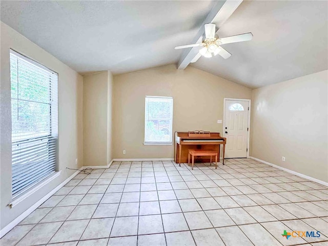 interior space featuring lofted ceiling with beams, plenty of natural light, ceiling fan, and light tile patterned flooring