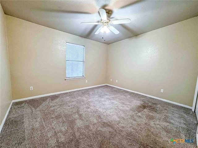 carpeted empty room with a textured ceiling and ceiling fan