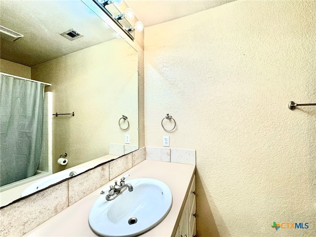 bathroom featuring vanity and a textured ceiling