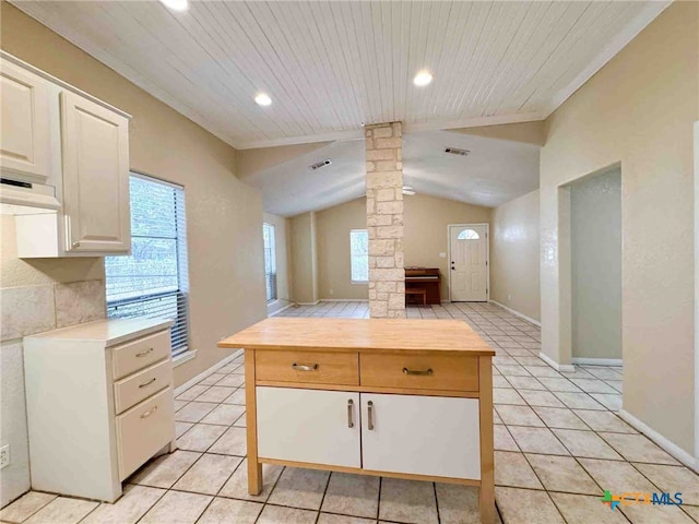 kitchen with light tile patterned floors, vaulted ceiling, decorative columns, and wooden ceiling