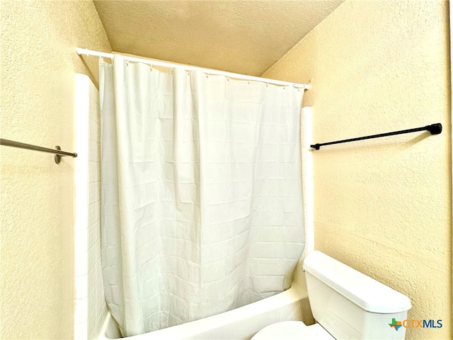 bathroom with a textured ceiling and toilet