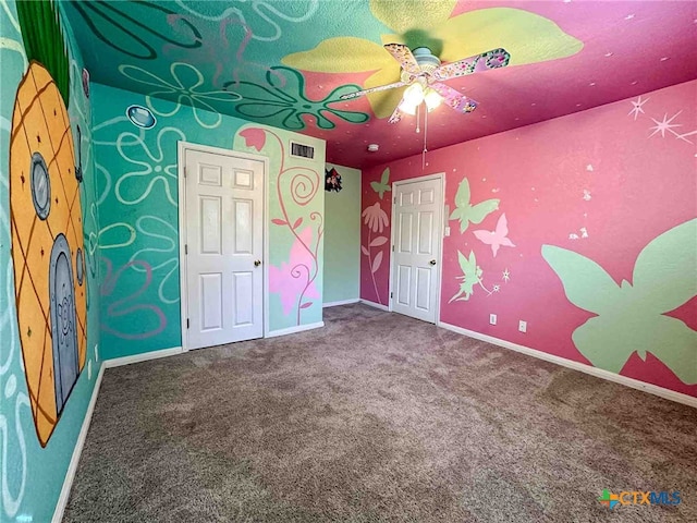 unfurnished bedroom featuring ceiling fan and carpet floors