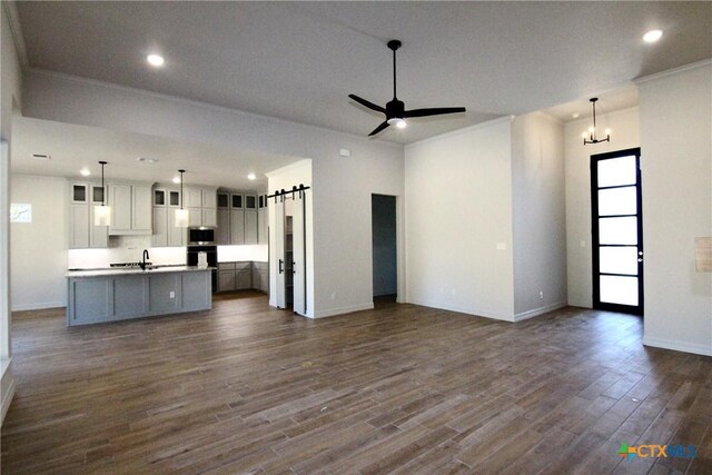 5715 Sparrow Ct, Temple, TX 76502 - kitchen with open floor plan, a sink, oven, recessed lighting, and crown molding