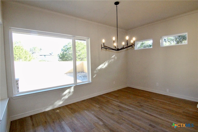 unfurnished dining area featuring crown molding, a notable chandelier, and hardwood / wood-style flooring