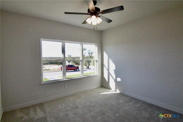5715 Sparrow Ct, Temple, TX 76502 - unfurnished room featuring healthy amount of natural light, carpet flooring, ceiling fan, and baseboards