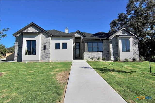 5715 Sparrow Ct, Temple, TX 76502 - view of front of property with stone siding, a front lawn, and a chimney