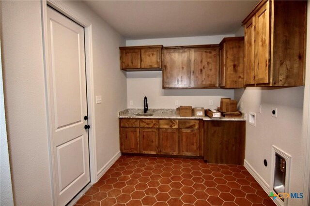 5715 Sparrow Ct, Temple, TX 76502 - laundry area with hookup for an electric dryer, cabinet space, hookup for a washing machine, and baseboards