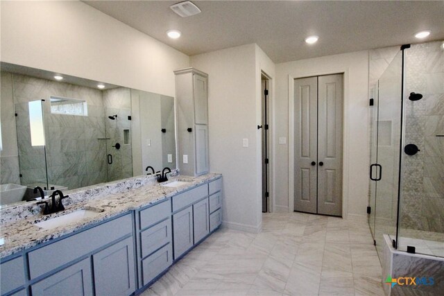 5715 Sparrow Ct, Temple, TX 76502 - bathroom with a shower stall, recessed lighting, marble finish floors, double vanity, and baseboards