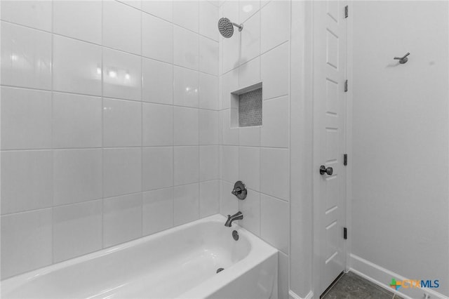 bathroom with baseboards and shower / tub combination