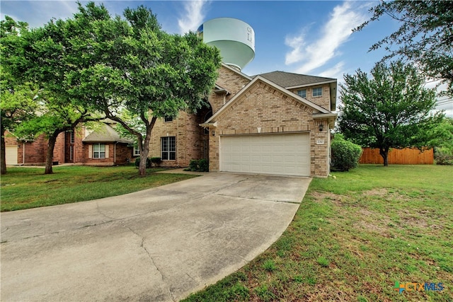 view of front of house with brick siding, an attached garage, a front yard, fence, and driveway