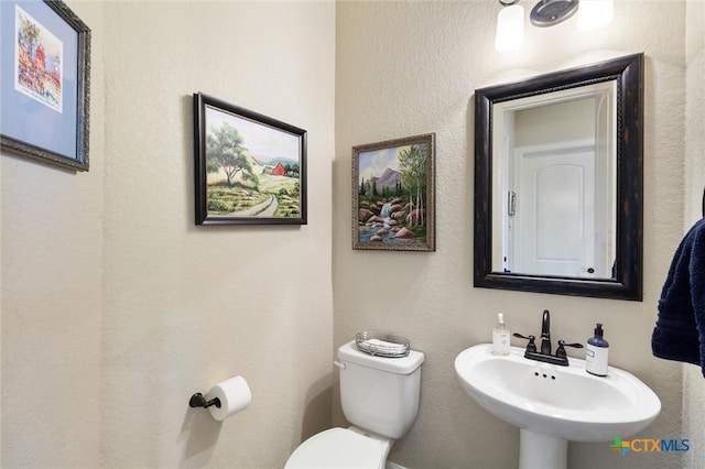 1919 Los Santos Dr, San Marcos, TX 78666 - half bathroom featuring a sink and toilet
