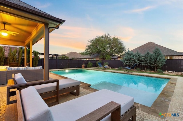 1919 Los Santos Dr, San Marcos, TX 78666 - pool at dusk with a patio area, a fenced backyard, a ceiling fan, and outdoor lounge area