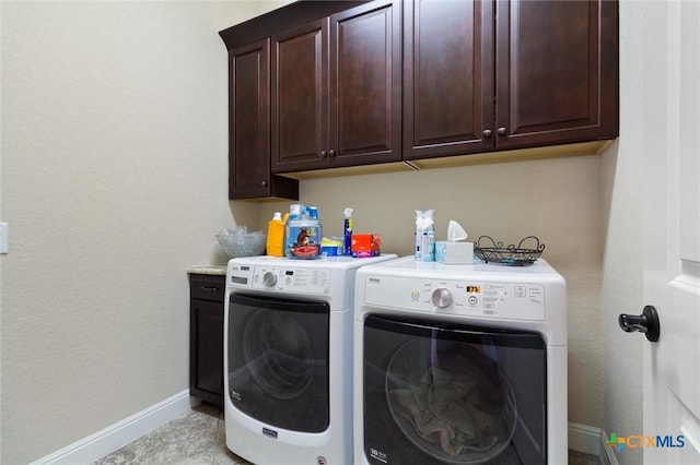 1919 Los Santos Dr, San Marcos, TX 78666 - laundry area featuring washing machine and dryer, baseboards, and cabinet space