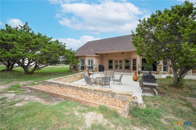 back of house featuring a yard and a patio