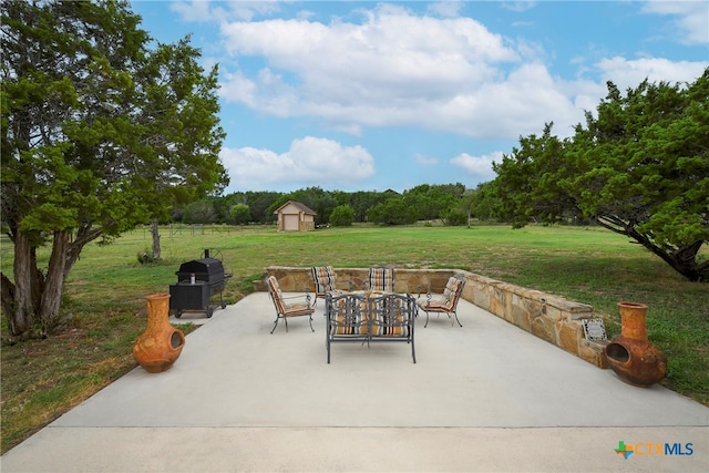 view of patio featuring a shed and a grill