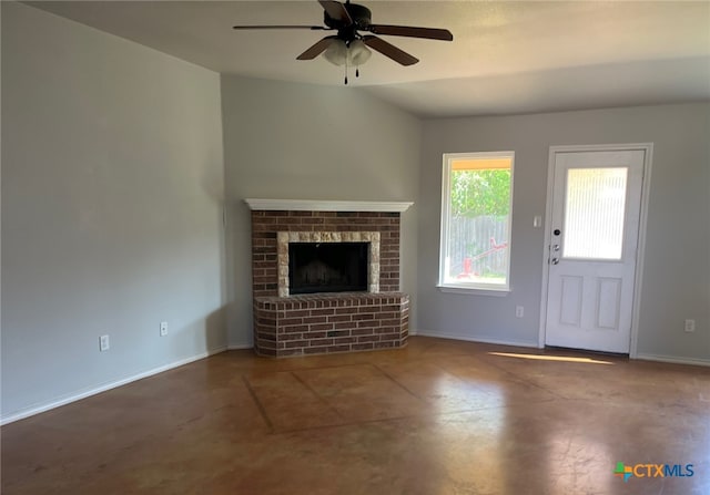 unfurnished living room featuring ceiling fan, a fireplace, finished concrete floors, lofted ceiling, and baseboards
