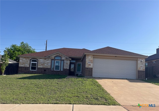 single story home with concrete driveway, a front yard, fence, and brick siding
