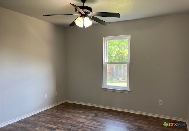 unfurnished room with dark wood-style flooring, baseboards, and a ceiling fan