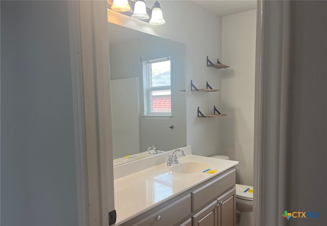 bathroom with vanity and toilet