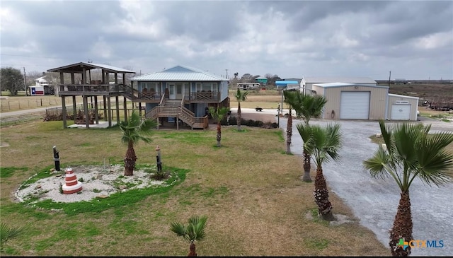 view of playground featuring an outbuilding, a lawn, and covered porch