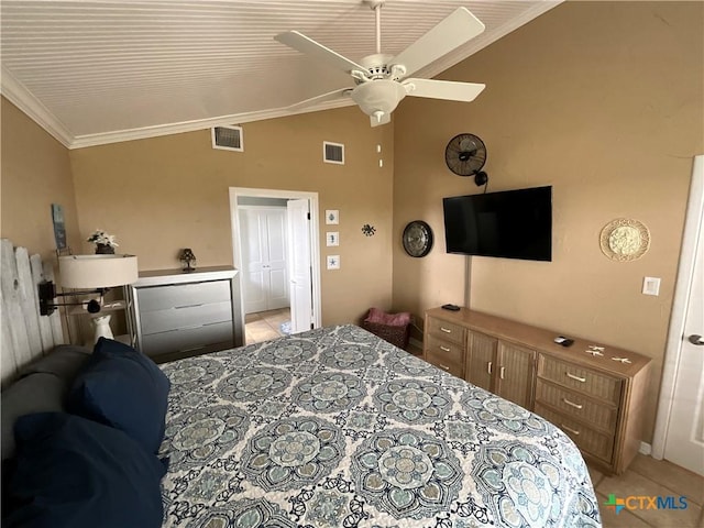 tiled bedroom with lofted ceiling, crown molding, and ceiling fan