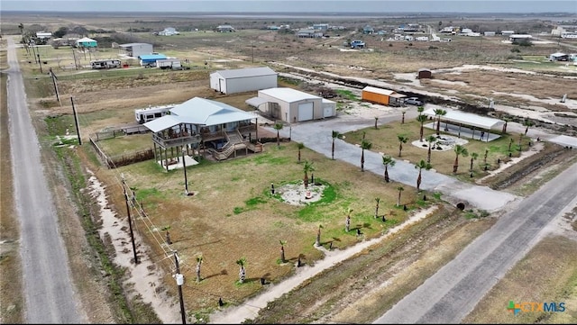 birds eye view of property with a rural view