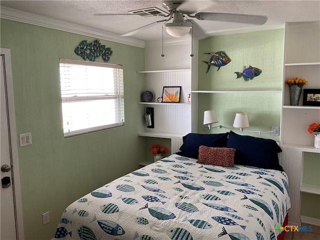 bedroom featuring crown molding, a textured ceiling, and ceiling fan