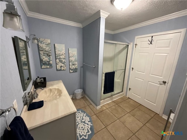 bathroom featuring ornamental molding, vanity, tile patterned floors, and walk in shower