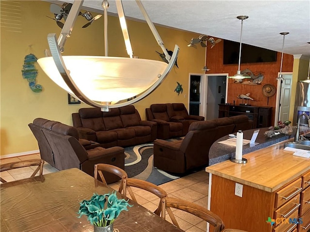 tiled living room featuring sink and vaulted ceiling