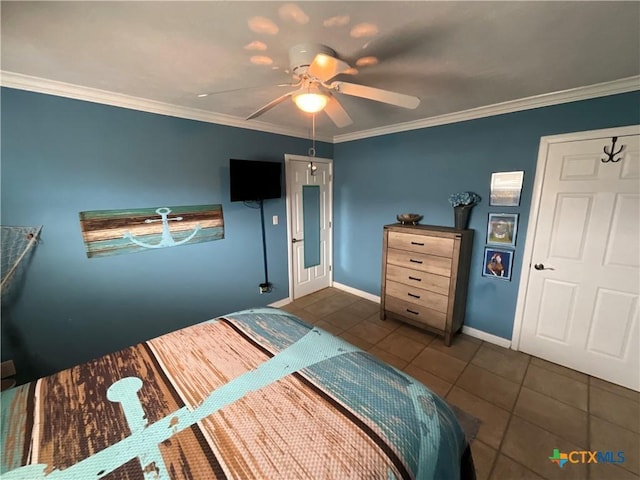 bedroom with dark tile patterned flooring, ornamental molding, and ceiling fan