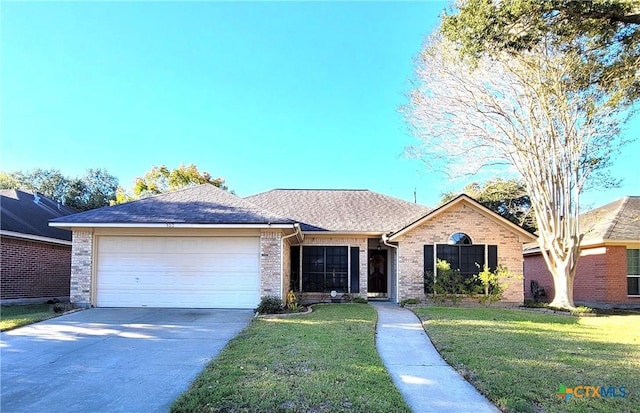 ranch-style home with a garage and a front lawn