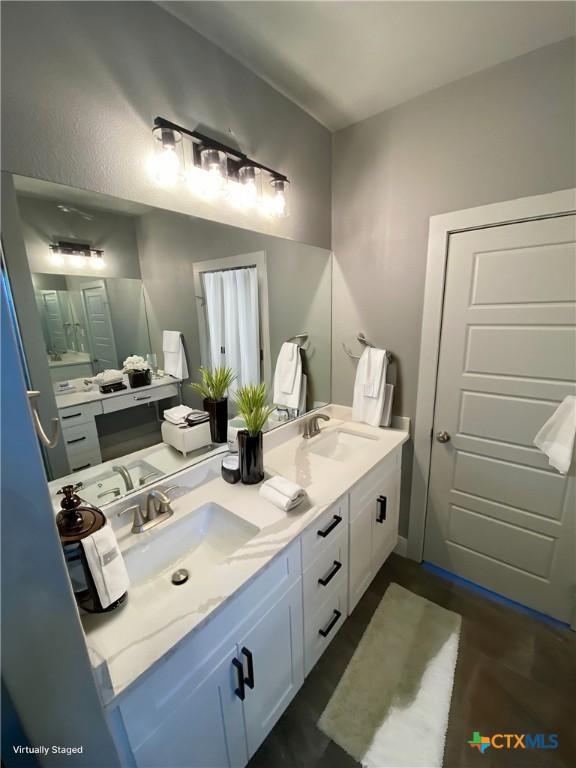 bathroom featuring double vanity and a sink