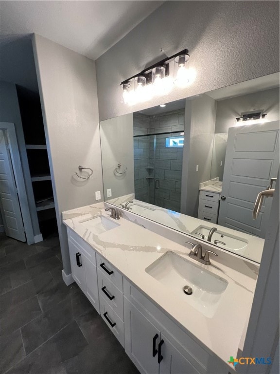 bathroom with vanity, an enclosed shower, and tile patterned floors