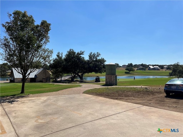 view of home's community featuring a water view and a yard