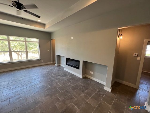 unfurnished living room featuring ceiling fan