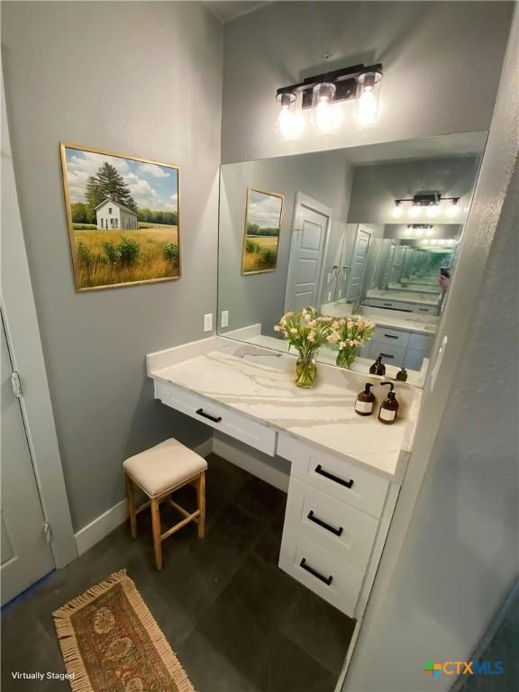 bathroom with vanity and baseboards