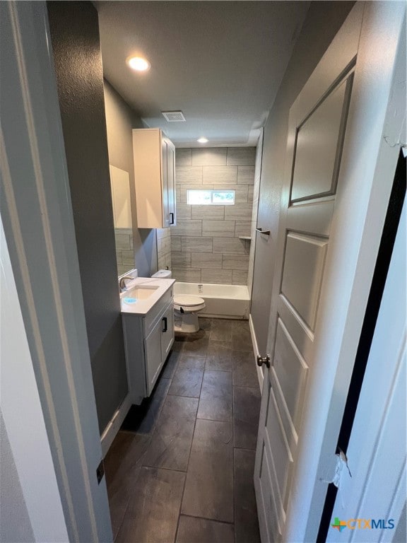 bathroom featuring tile patterned floors, vanity, and toilet