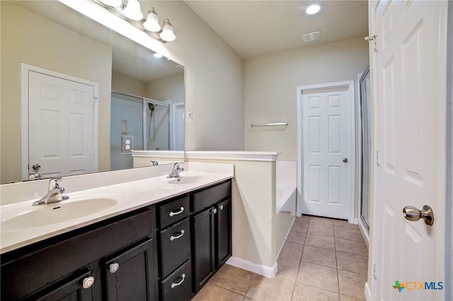 bathroom with shower with separate bathtub, tile patterned floors, and vanity