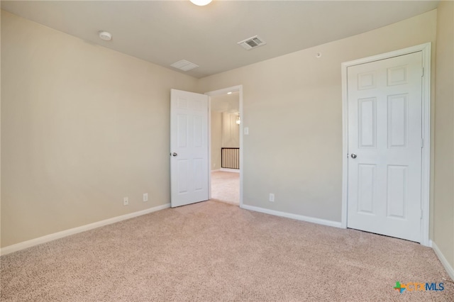 unfurnished bedroom with light carpet