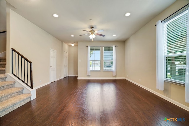 unfurnished living room with ceiling fan and dark hardwood / wood-style floors