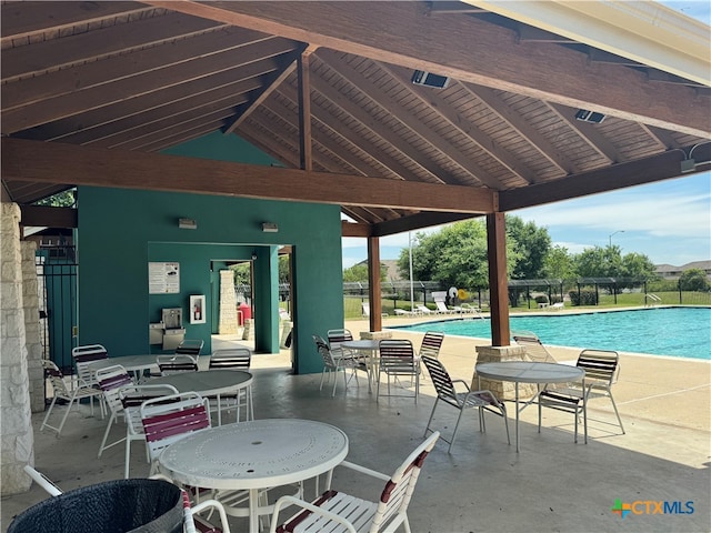 view of patio / terrace featuring a community pool and a gazebo