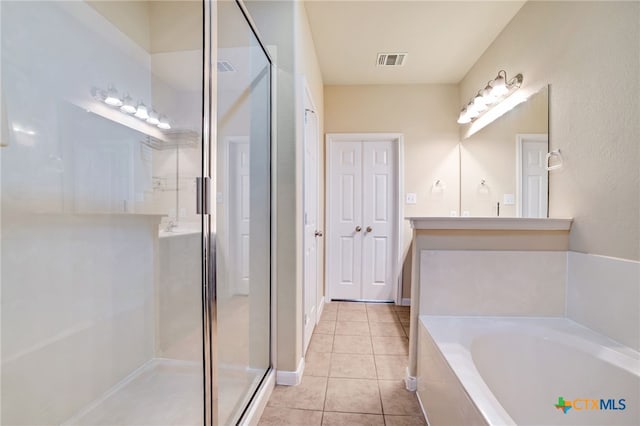 bathroom featuring vanity, plus walk in shower, and tile patterned floors