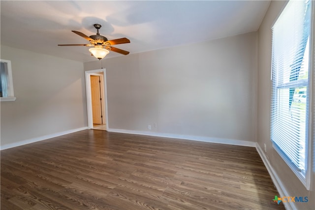 empty room featuring dark hardwood / wood-style floors and ceiling fan