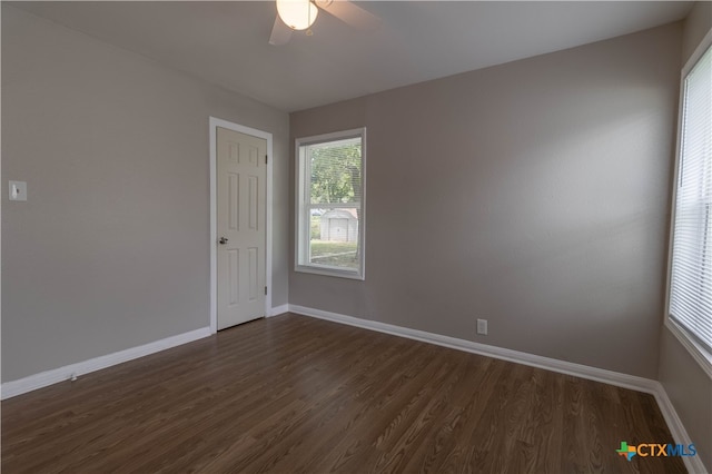 spare room featuring ceiling fan and dark hardwood / wood-style floors