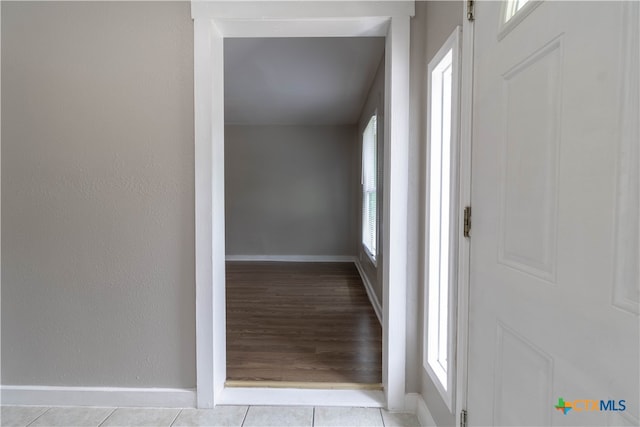 corridor with light hardwood / wood-style floors and plenty of natural light