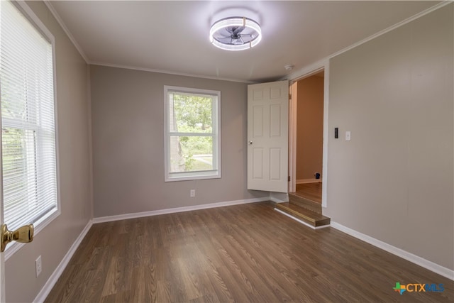 unfurnished room with dark hardwood / wood-style floors and ornamental molding