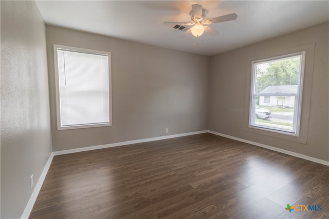 unfurnished room featuring ceiling fan and dark wood-type flooring