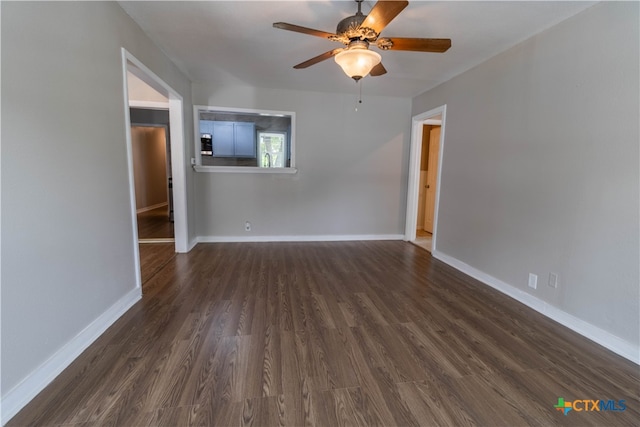 spare room with ceiling fan and dark hardwood / wood-style floors